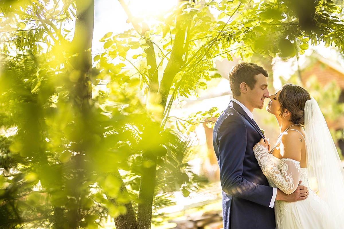 Grace and Alex share a quiet portrait under the trees during their Ste. Genevieve wedding day