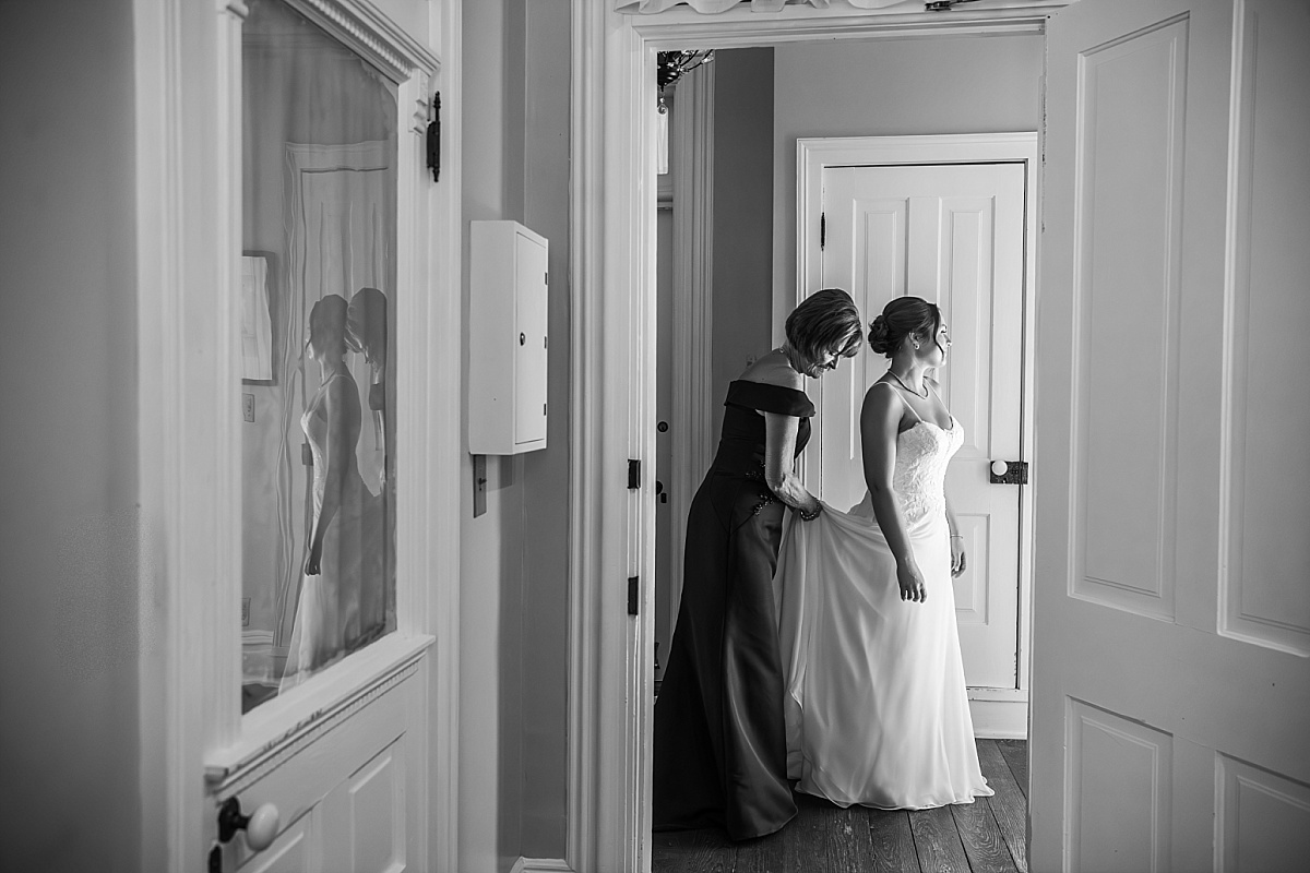 Grace is helped into her wedding dress while getting ready at Main Street Inn in Ste. Genevieve