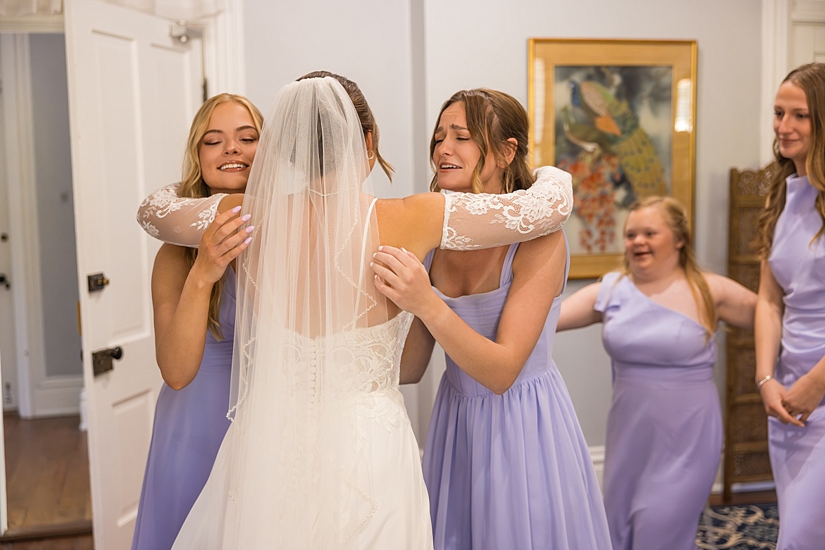 Grace hugs her bridesmaids before the wedding ceremony in Ste. Genevieve