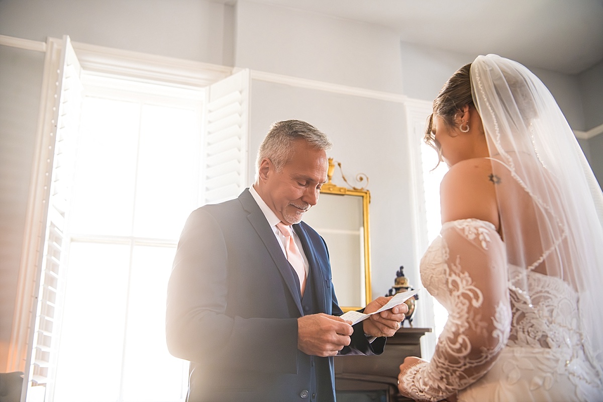 Grace’s father reads a note to her before the wedding ceremony