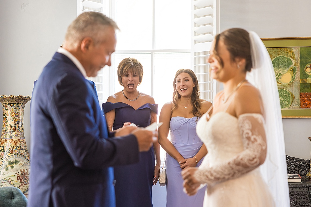 Family and bridesmaids react as Grace’s father reads a note before the ceremony