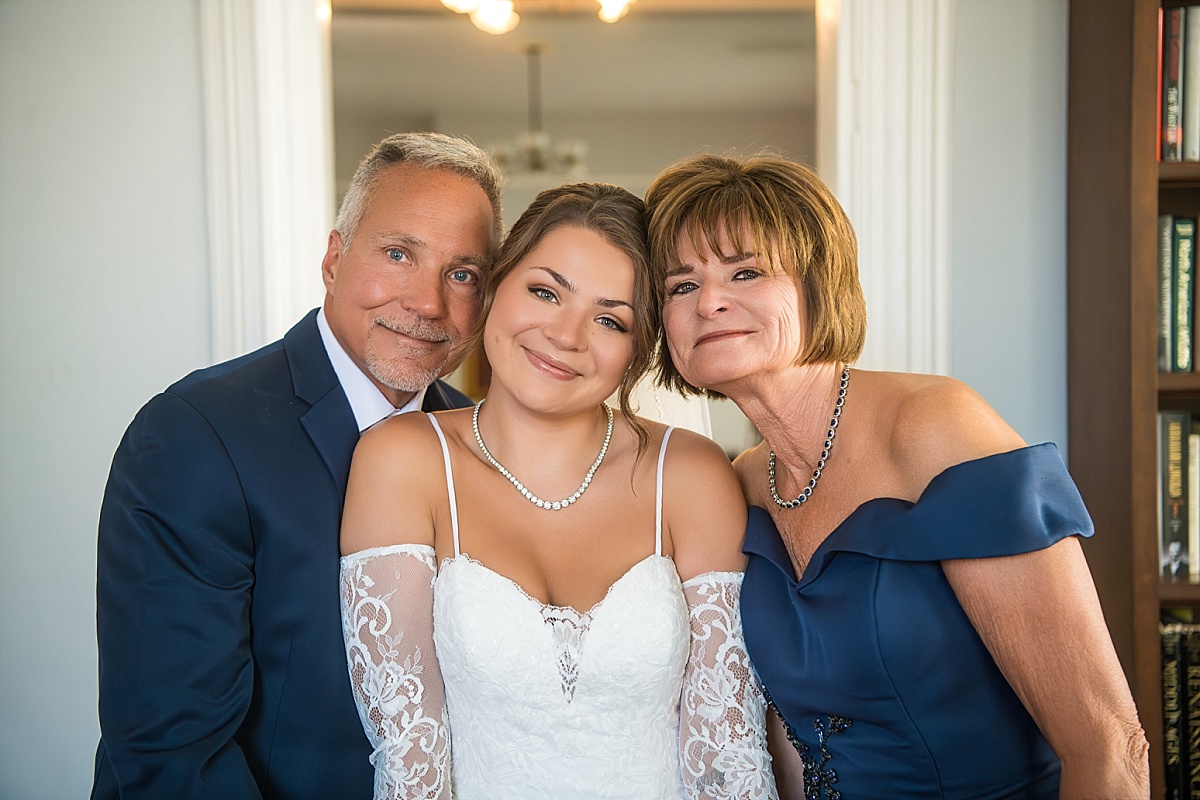 Grace poses with her parents before her Ste. Genevieve wedding ceremony