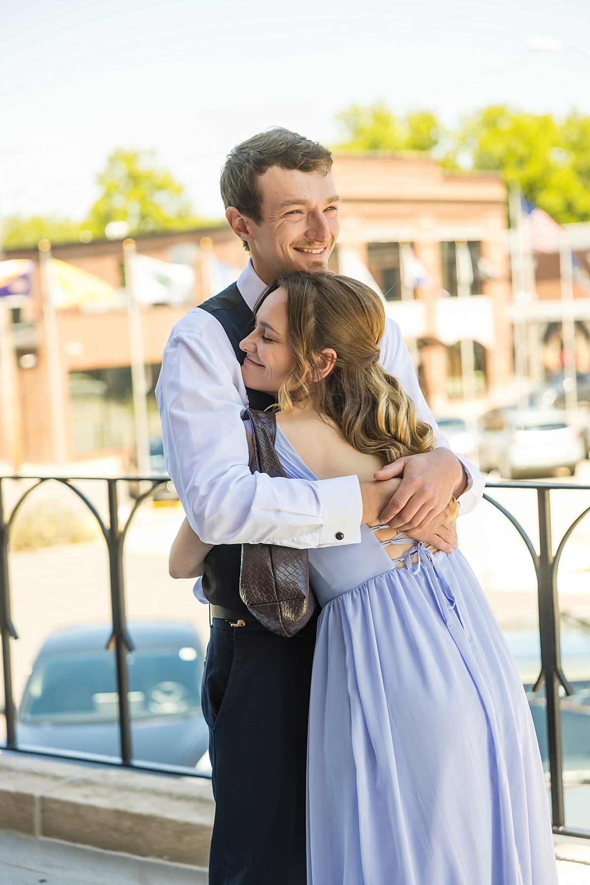 A wedding party member hugs Alex before the ceremony in downtown Ste. Genevieve