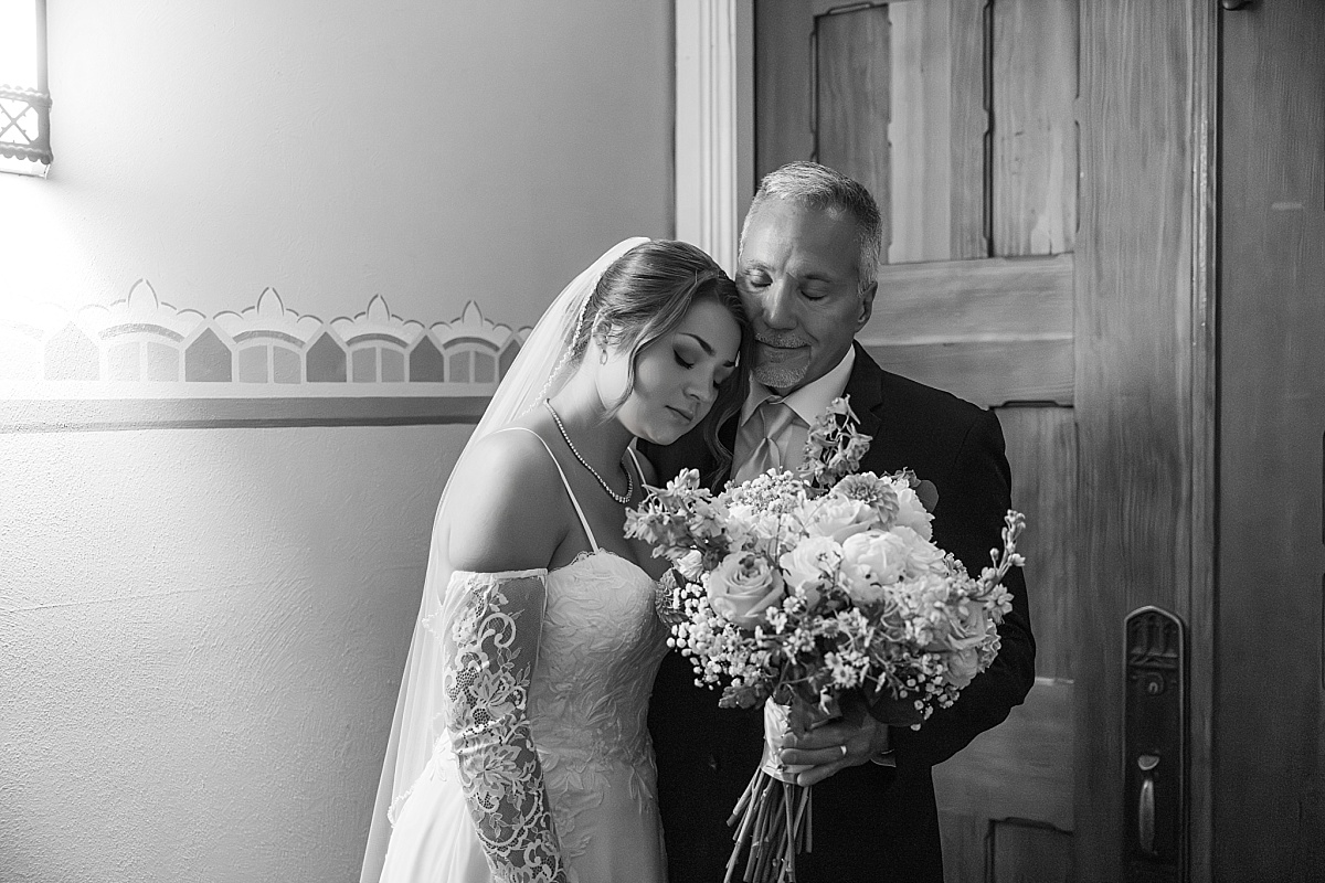 Black and white photo of Grace and her father before walking into the ceremony