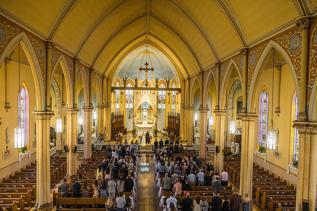 Wide view of Grace and Alex’s wedding ceremony inside Ste. Genevieve Catholic Church