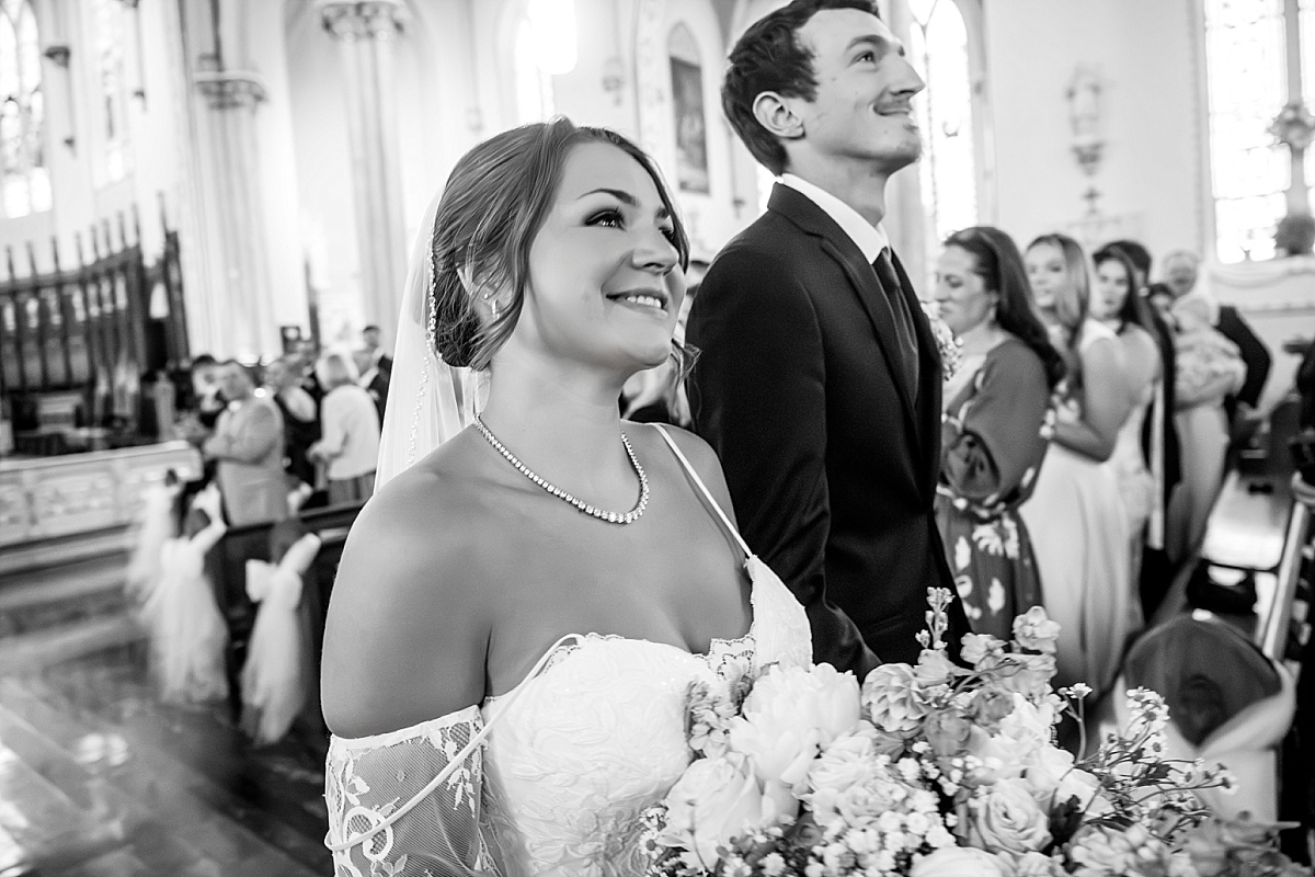 Black and white photo of Grace and Alex smiling after their wedding ceremony