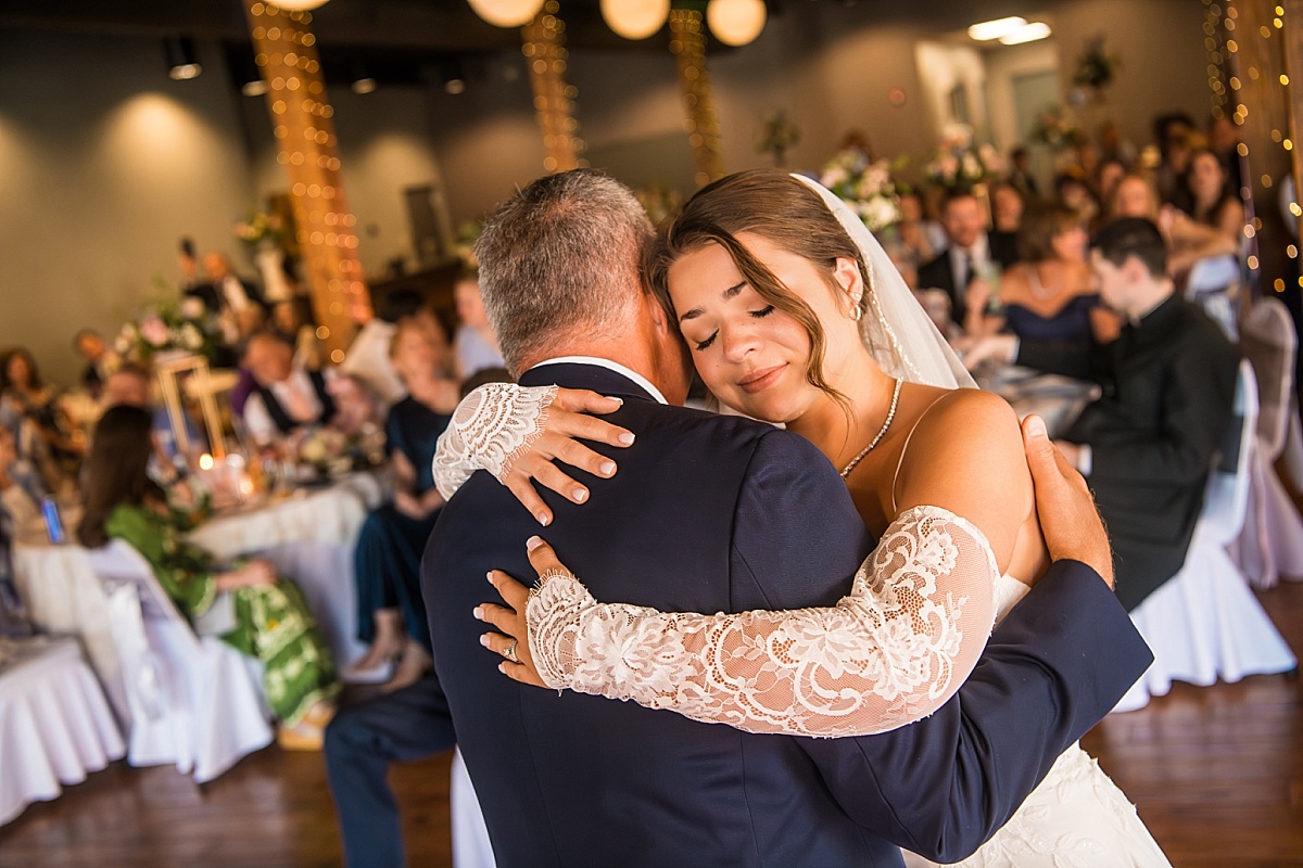 Grace hugs her father during an emotional reception dance at DuBourg Centre