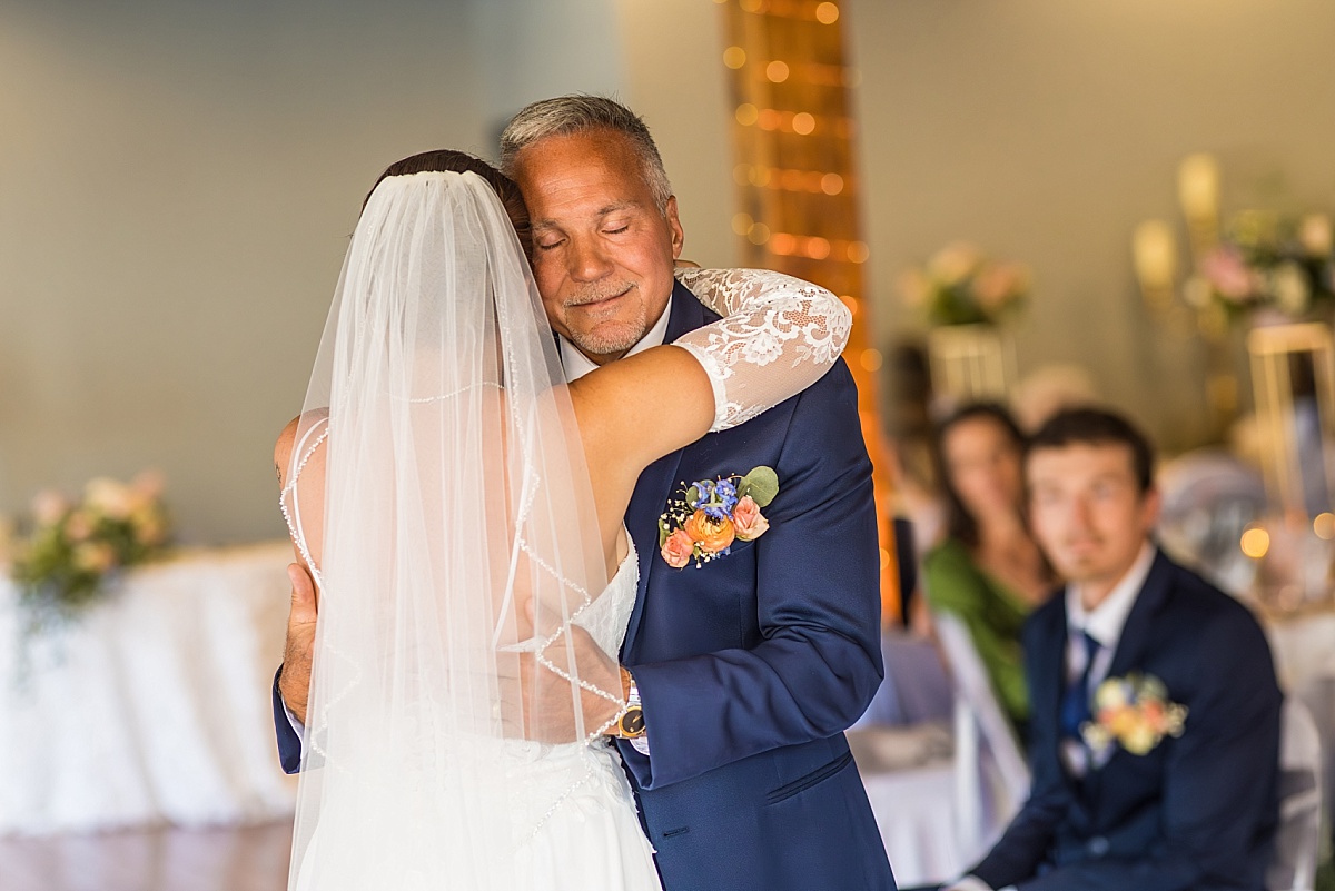 Grace hugs her father during an emotional reception dance at DuBourg Centre