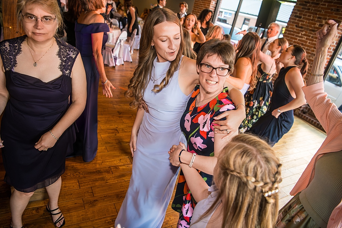 Wedding guests dance and laugh during the DuBourg Centre reception
