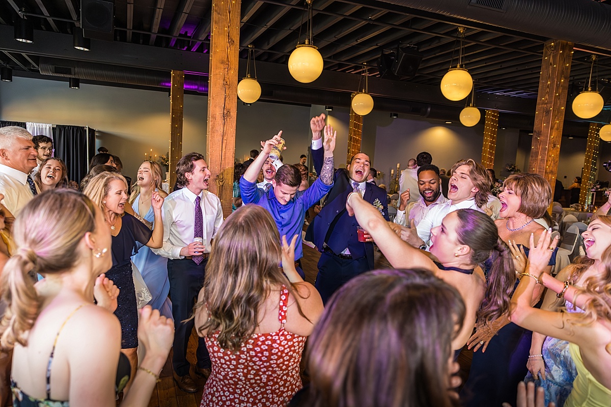 Wedding guests dance and laugh during the DuBourg Centre reception