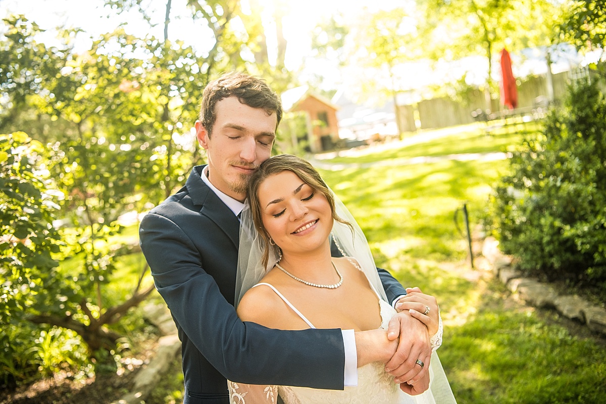 Grace and Alex share a peaceful garden portrait on their Ste. Genevieve wedding day