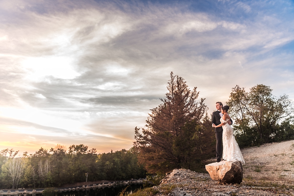 Melicia and Justin share a sunset portrait on a rocky outcrop at Sunset Bluffs in Washington, Missouri.