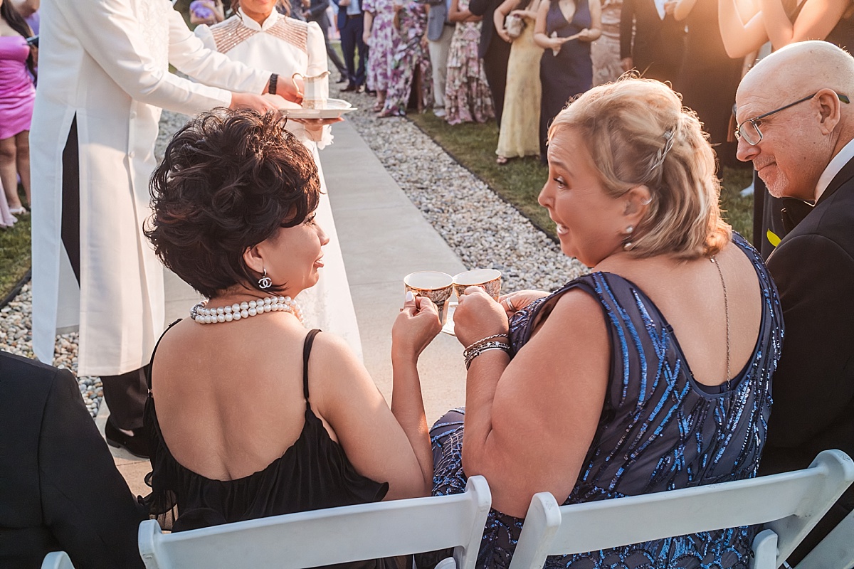 Melicia's family members share tea and smiles during the Vietnamese wedding tea ceremony.